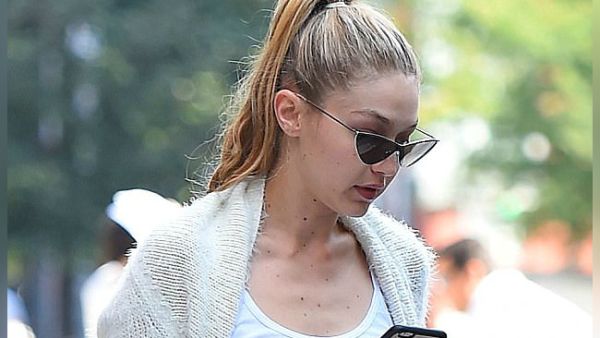 Gigi Hadid checks her phone. (Buzz Foto / Rex / Shutterstock)