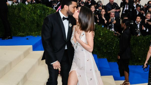 Selena Gomez and The Weeknd kiss. (Sky Cinema / Shutterstock.com)