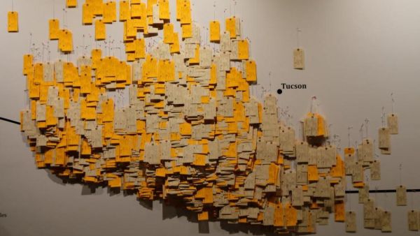 A new exhibit uses toe tags with the names of dead migrants found at the Arizona-Mexico border from 1994 as a graphic reminder that crossing borders claims lives. (Photo courtesy of "Hostile Terrain 94.")