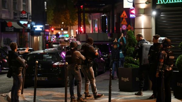 Police check passersby near the Champs Elysees in Paris after a shooting which left one officer dead and two wounded. (AFP/Franck Fife) 