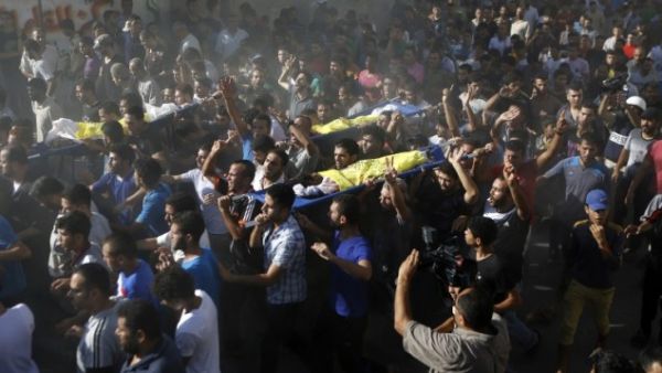 Mourners attend a funeral for Palestinian boys from the Bakr family, who were killed on a beach in 2014. (AFP/File)