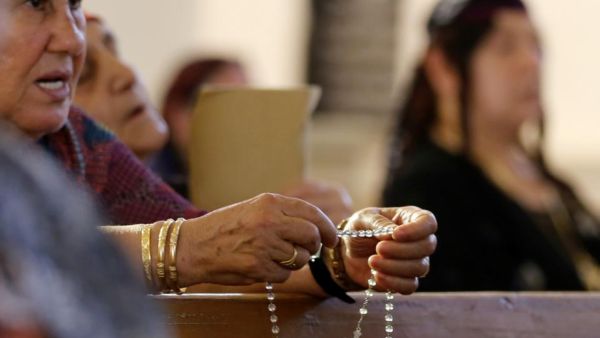 Christian women from outside Mosul pray at a church in Erbil, the capital of Iraqi Kurdistan. (AFP/Karim Sahib)