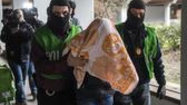 Police officers escort a man who was arrested in a flat during a raid on February 4, 2016 in Berlin. (AFP/Odd Andersen)
