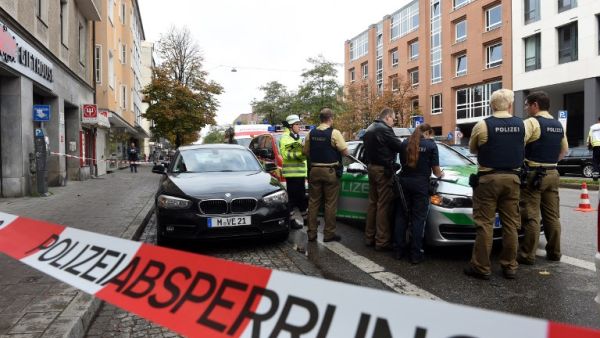 German police stands inside a security perimeter set after a man attacked passersby near Rosenheimer square in the southern German city of Munich on October 21, 2017 (Christof Stache/AFP)
