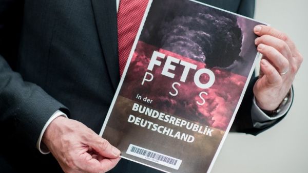 Lower Saxony's Interior Minister Boris Pistorius holds the cover of a list with the names of alleged supporters of the Gulen movement that was handed over to Germany's Federal Intelligence Service (BND) by representatives of the Turkish intelligence service on March 28, 2017. (AFP/Hauke-Christian Dittrich)