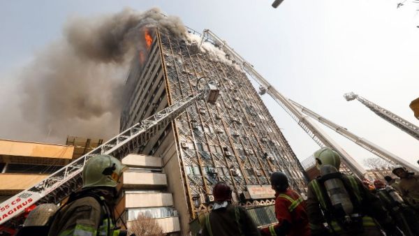 Firefighters battle a blaze that engulfed Iran's oldest high-rise, the 15-storey Plasco building in downtown Tehran on January 19, 2017. (AFP/Stringer)