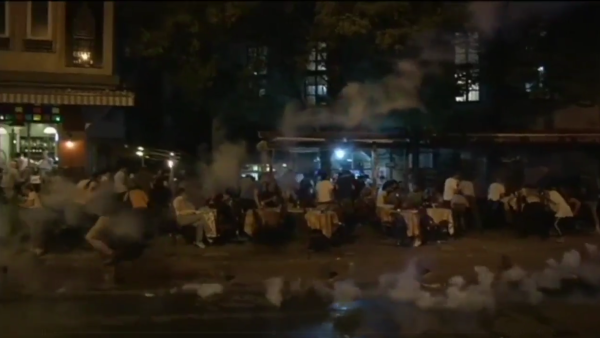 Gay pride supporters are fired upon with tear gas by Turkish forces. (Twitter/@b9AcE)