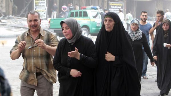 The mother (2nd L) of 16-year-old Iraqi Nabil Abdul Karim, who died in a massive bombing in Baghdad's Karada neighborhood as he went to celebrate his birthday, reacts as she visits the aftermath of the attack on July 4, 2016. (AFP/Sabah Arar)