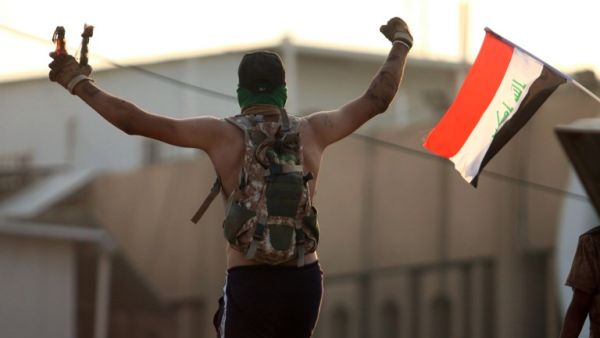 An Iraqi protestor waves fire bombs during a protest outside the regional government headquarters in the southern city of Basra on September 5, 2018. (Haidar MOHAMMED ALI / AFP)