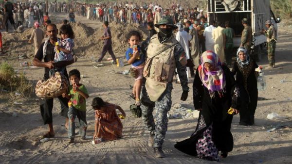 A displaced Iraqi family arrives at a safe zone on June 17, 2016 in Amiriyiah al-Fallujah, after Iraqi government forces evacuated civilians from Fallujah due to their ongoing military operation to retake the city from the Islamic State group. [AFP/Moadh Al-Dulaimi]