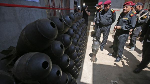 Iraqi commanders Abdul Ghani al-Asadi and Ma'an al-Saadi check a weapons store left by Islamic State (group) fighters in a house in western Mosul on May 21, 2017, during the ongoing offensive to retake the area from the jihadists. (Ahmad Al-Rubaye/AFP)