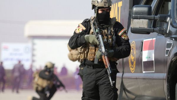 Iraqi SWAT policemen show their skills during a ceremony to mark the 95th anniversary of the creation of the Iraqi police at the Shaabiyah training camp in the southern city of Basra on January 9, 2017. (AFP/Haidar Mohammed Ali)