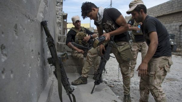 Members of the Iraqi forces get ready in Mosul's northwestern al-Haramat neighborhood before going to the front line on May 13, 2017, during the ongoing offensive to retake the city from Daesh fighters. (AFP/Fadel Senna)