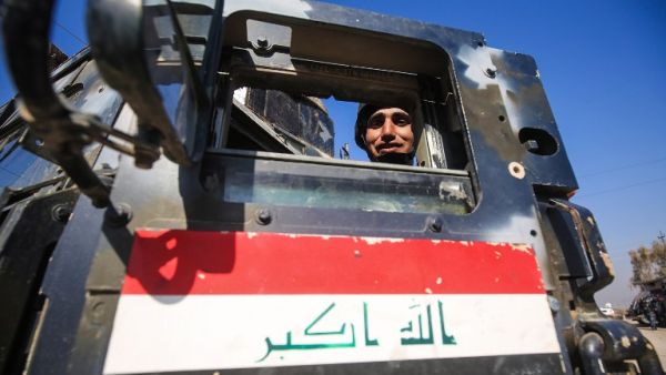 A member of the Iraqi security forces poses from inside an armored vehicle in the village of al-Buseif, south of Mosul, during an offensive by Iraqi forces to retake the western side of the city from Daesh on February 22, 2017. (AFP/Ahmad al-Rubaye)