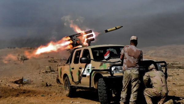 Members of the Iraqi army's 9th Division fire a multiple rocket launcher from a hill in Talul al-Atshana, on the southwestern outskirts of Mosul, on February 27, 2017. (AFP/Aris Messinis)
