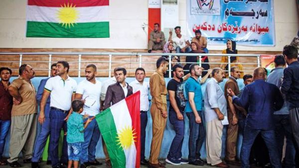 People queue to cast their votes on the Kurdish independence referendum at a stadium in Arbil yesterday. (AFP Photo)