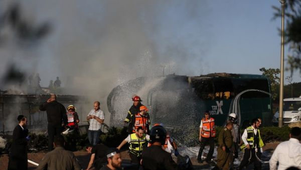 Firefighters respond to the scene of the Jerusalem bus blast. (AFP/Ahmad Gharabli)