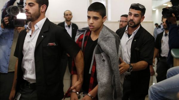 Ahmed Manasra (C), a 14-year old Palestinian boy, convicted of the attempted murder of two Israelis in a stabbing in October 2015, leaves the District Court in Jerusalem after his sentencing hearing on November 7, 2016. (AFP/Ahmad Gharabli)
