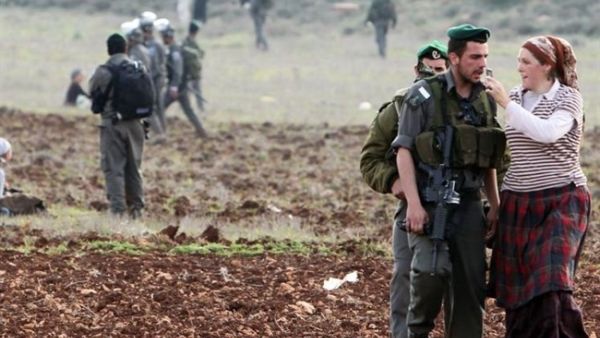 Israeli forces talk with Jewish settlers from the Esh Kodesh outpost as they stage a sit-in to prevent Palestinians from working in their fields, Jan. 2, 2013. (AFP/Jaafar Ashtiyeh)