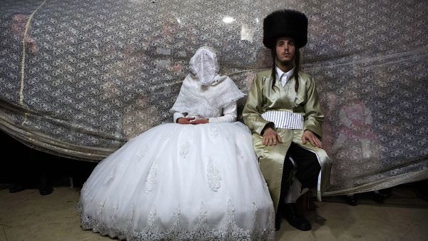 A Jewish bride sits next to her groom during the Mitzvah Tans dance ritual following their wedding in an ultra-orthodox neighbourhood in Jerusalem. (AFP/File)  