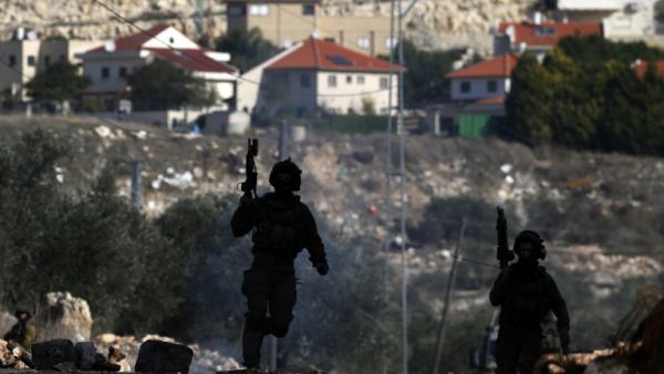 Israeli security forces take position near the settlement of Kadumim during clashes following a demonstration against the expropriation of Palestinian land by Israel in the village of Kfar Qaddum, in the occupied West Bank, on December 23, 2016. (AFP/Jaafar Ashtiyeh)