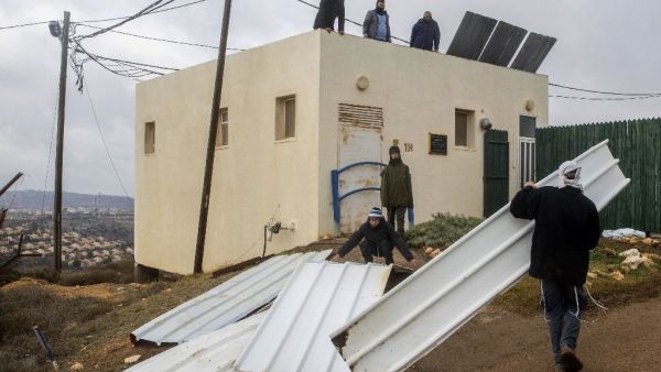 Israeli settlers block the entrance to the the settlement outpost of Amona, in the Israeli-occupied West Bank. (AFP/File)