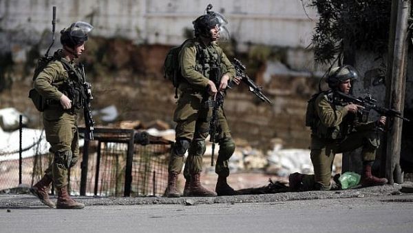 Israeli security forces stand in the street during clashes with Palestinian demonstrators in the West Bank city. (AFP/File)