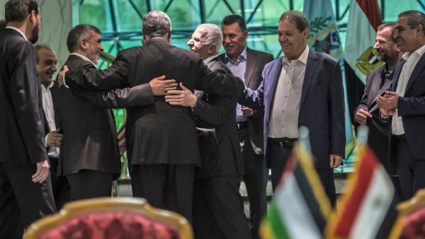 Khaled Fawzi (3rd-L) head of the Egyptian Intelligence services, shares a laugh with Hamas leader Izzat al-Rishq (2nd-L) and Fatah's Azzam al-Ahmad (C) following the signing of a reconciliation deal in Cairo on October 12, 2017 (Khaled Desouki/AFP) Khaled Fawzi (3rd-L) head of the Egyptian Intelligence services, shares a laugh with Hamas leader Izzat al-Rishq (2nd-L) and Fatah's Azzam al-Ahmad (C) following the signing of a reconciliation deal in Cairo on October 12, 2017 (Khaled Desouki/AFP)