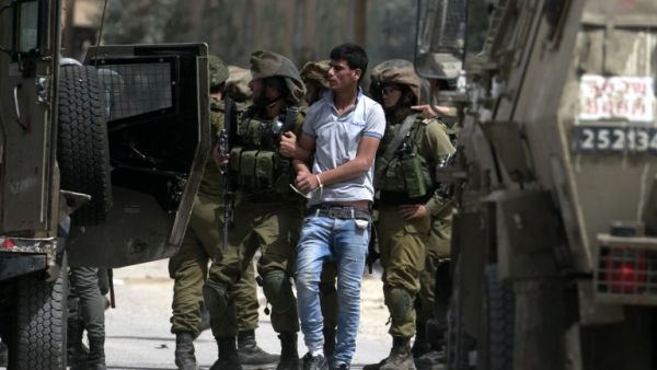 Israeli soldiers arrest Palestinian demonstrators amid clashes in the West Bank village of Beita, southeast of Nablus city, after a protest took place following Friday prayers in solidarity with Palestinian prisoners on hunger strike in Israeli jails, on April 21, 2017. (AFP/Jaafar Ashtiyeh)