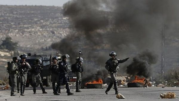 Israeli forces take position during clashes with Palestinian protesters in the West Bank village of Betunia near Ramallah on December 7, 2017. (AFP/ File Photo)