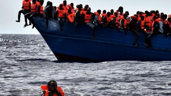 Migrants wait to be rescued as they drift in the Mediterranean Sea some 20 nautical miles north off the coast of Libya. (AFP/Aris Messinis)