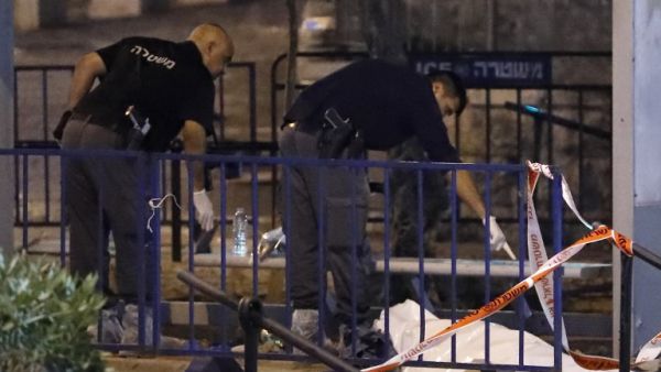 Israeli forensic police check the body of a suspected Palestinian assailant outside Damascus Gate in Jerusalem's Old City on June 16, 2017 following an attack. (Thomas Coex/AFP)