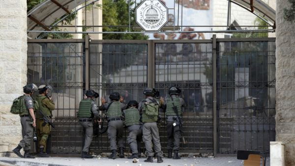 Israeli guards stand outside the gate of al-Quds University in 2015. (AFP/File)