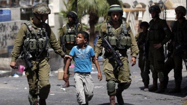 According to the PLO's Authority of Prisoners' Affairs, 1,266 Palestinian children below the age of 15, had spent time in Israeli detention in 2014. (AFP/File)