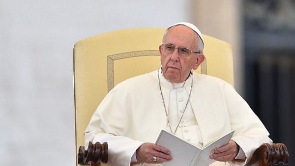 Pope Francis received a copy of 'Fortress of Peace: Jordan’s Interfaith Drive and Model of Coexistence' by Jordanian reporter and author Rula Samain book. (AFP/Vincenzo Pinto)
