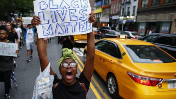 A protester holds a sign at a Black Lives Matter protest in the USA (AFP)