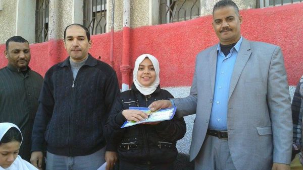 Yasser Muhammad Rashid (center left) outside the Kufr Suleiman Musa School (Facebook).