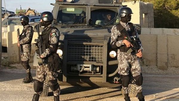 Jordanian security forces are seen on December 19, 2016 during the funeral of victims who were killed a day earlier in an attack at in Karak. (AFP/ KHALIL MAZRAAWI)