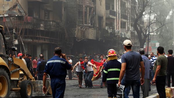 People evacuate victims after the July Daesh attack in Baghdad's Karada district (AFP/File)