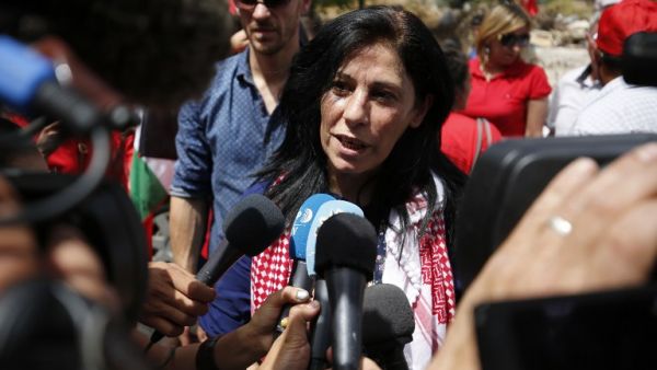 Prominent Palestinian lawmaker Khalida Jarrar greets speaks to reporters in her hometown, the West Bank city of Ramallah, following her release from an Israeli jail on June 3, 2016. (AFP/Abbas Momani)