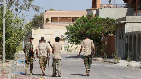 Fighters from the pro-government forces loyal to Libya's Government of National Unity (GNA) walk on August 3, 2016 in Sirte during an operation against Daesh. (AFP/Mahmud Turkia)