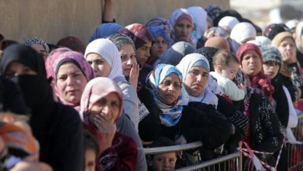 Syrian women wait in Arsal, Lebanon. (AFP/File)