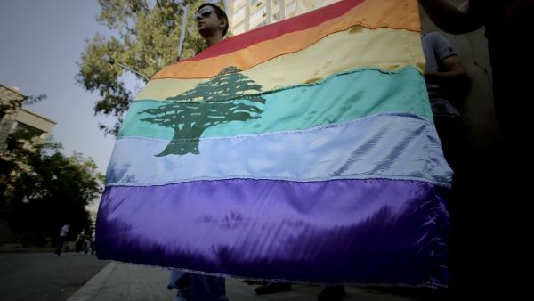 A Lebanese pride flag flies at a 2013 anti-homophobia rally in Beirut (Joseph Eid/AFP)