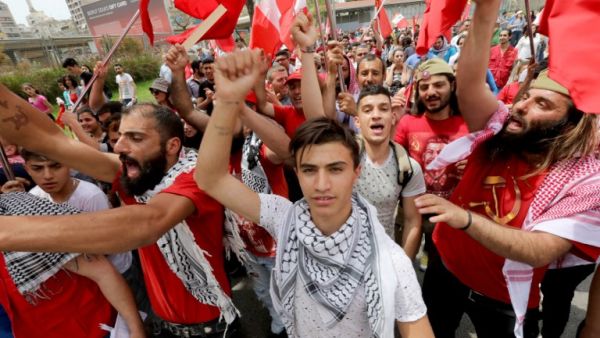 Supporters of the Lebanese Communist party take part in an International Workers' Day rally in Beirut (ANWAR AMRO/AFP)