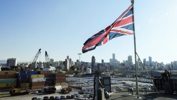 The Union Jack flies from the British Royal Navy's HMS Ocean (L12) amphibious assault ship and helicopter carrier as it lies docked in the port of Beirut. (AFP/Anwar Amro)