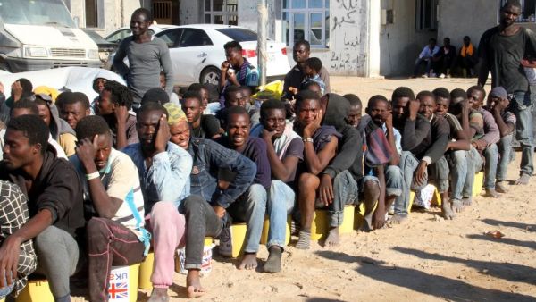 Migrants sit in a port in Tagiura, east of the Libyan capital Tripoli, after 137 people were rescued by coast guard boats off the coast of Libya on July 21, 2016. (AFP/Stringer)