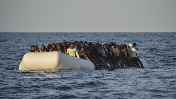 Migrants and refugees on a rubber boat before to be rescued by the ship Topaz Responder run by Maltese NGO Moas and the Red Cross, off the Libyan coast in the Mediterranean Sea, on November 3, 2016. (AFP/Andreas Solaro)