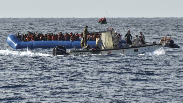 This file photo taken on November 04, 2016 shows migrants and refugees on a rubber boat as the Libyan coastguards patrol on November 4, 2016 off the Libyan coast. (Andreas Solaro/AFP)