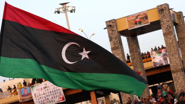 The new Libyan flag is raised during a parade in the eastern city of Benghazi to celebrate the second anniversary of Nato's first military operation in Libya. (AFP/ File)