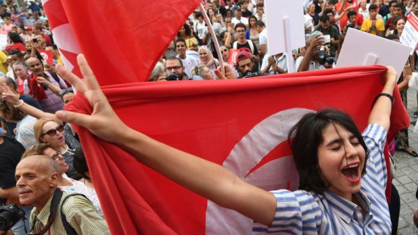An image was taken from protests in Tunisia for women celebrating the president's proposal for an amended inheritance law that grants women equal rights with men. (AFP)